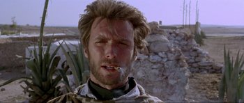 Movie still from “For a Few Dollars More” (1965), directed by Sergio Leone – A person smoking a cigarette; Close Up shot, Low angle