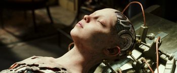 Movie still from “Alita: Battle Angel” (2019), directed by Robert Rodriguez – A woman is laying down with her eyes closed; Close Up shot, High angle