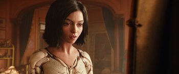 Movie still from “Alita: Battle Angel” (2019), directed by Robert Rodriguez – A person with short black hair; Close Up shot, Over the shoulder angle