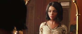 Movie still from “Alita: Battle Angel” (2019), directed by Robert Rodriguez – A young woman standing in front of a bathroom mirror; Close Up shot, Over the shoulder angle