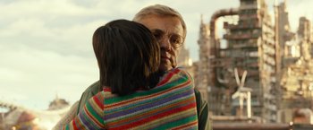Movie still from “Alita: Battle Angel” (2019), directed by Robert Rodriguez – An older man hugging a younger woman outside; Close Up shot, Over the shoulder angle