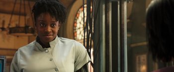 Movie still from “Alita: Battle Angel” (2019), directed by Robert Rodriguez – A woman standing in front of a stained - glass window; Close Up shot, Low angle