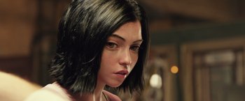 Movie still from “Alita: Battle Angel” (2019), directed by Robert Rodriguez – A person with short black hair; Close Up shot, High angle