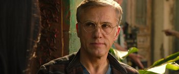 Movie still from “Alita: Battle Angel” (2019), directed by Robert Rodriguez – A person wearing glasses and a jacket; Close Up shot, Low angle