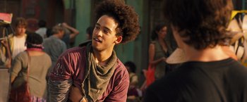 Movie still from “Alita: Battle Angel” (2019), directed by Robert Rodriguez – A man with a beard and a scarf around his neck; Close Up shot, Over the shoulder angle