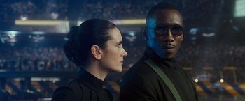 Movie still from “Alita: Battle Angel” (2019), directed by Robert Rodriguez – A man and a woman standing next to each other; Close Up shot, Over the shoulder angle