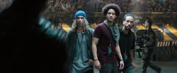 Movie still from “Alita: Battle Angel” (2019), directed by Robert Rodriguez – Two young men are walking together in a crowd of people; Medium shot, Low angle