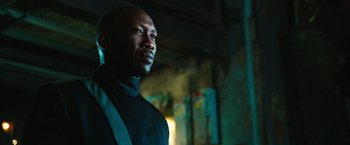 Movie still from “Alita: Battle Angel” (2019), directed by Robert Rodriguez – A man wearing a black shirt and a black tie; Close Up shot, Low angle