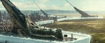 Movie still from “Alita: Battle Angel” (2019), directed by Robert Rodriguez – An aerial view of a city with a river running through it; Extreme Wide shot, High angle