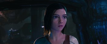 Movie still from “Alita: Battle Angel” (2019), directed by Robert Rodriguez – A person wearing a shirt; Close Up shot, Low angle