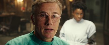 Movie still from “Alita: Battle Angel” (2019), directed by Robert Rodriguez – An older man wearing glasses and wearing a green shirt; Close Up shot, Over the shoulder angle