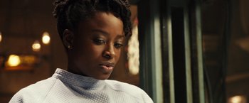 Movie still from “Alita: Battle Angel” (2019), directed by Robert Rodriguez – A person wearing a white shirt; Close Up shot, Over the shoulder angle