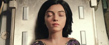 Movie still from “Alita: Battle Angel” (2019), directed by Robert Rodriguez – A woman with her eyes closed with her eyes closed; Close Up shot, Overhead angle