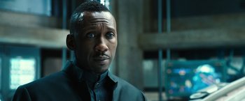 Movie still from “Alita: Battle Angel” (2019), directed by Robert Rodriguez – A person wearing a suit and tie; Close Up shot, Over the shoulder angle