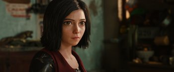 Movie still from “Alita: Battle Angel” (2019), directed by Robert Rodriguez – A person with short black hair; Close Up shot, Over the shoulder angle