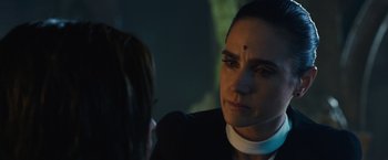 Movie still from “Alita: Battle Angel” (2019), directed by Robert Rodriguez – A woman in a priest's outfit looking at another woman; Close Up shot, Over the shoulder angle
