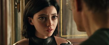 Movie still from “Alita: Battle Angel” (2019), directed by Robert Rodriguez – A person's face as a person looks on; Close Up shot, Over the shoulder angle