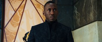 Movie still from “Alita: Battle Angel” (2019), directed by Robert Rodriguez – A man wearing a black jacket looking at the camera; Close Up shot, Low angle