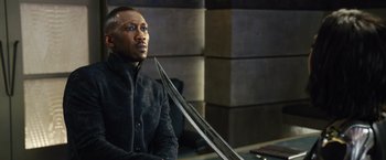 Movie still from “Alita: Battle Angel” (2019), directed by Robert Rodriguez – A man holding a knife in his right hand; Close Up shot, Over the shoulder angle