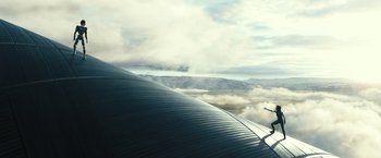 Movie still from “Alita: Battle Angel” (2019), directed by Robert Rodriguez – An aerial view of a plane wing and a plane flying in the sky; Extreme Wide shot, Low angle