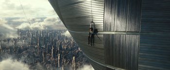 Movie still from “Alita: Battle Angel” (2019), directed by Robert Rodriguez – A man hanging from the side of a building; Extreme Wide shot, Overhead angle