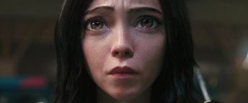 Movie still from “Alita: Battle Angel” (2019), directed by Robert Rodriguez – A woman's face with brown eyes; Extreme Close Up shot, High angle