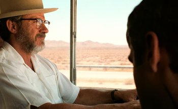 Movie still from “From Dusk Till Dawn” (1996), directed by Robert Rodriguez – An older man wearing a white shirt and a cowboy hat; Close Up shot, Over the shoulder angle