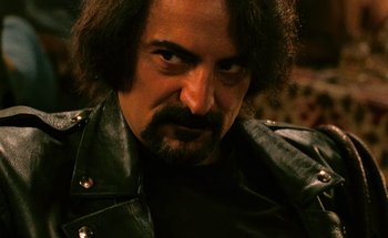 Movie still from “From Dusk Till Dawn” (1996), directed by Robert Rodriguez – A person wearing a leather jacket; Close Up shot, Over the shoulder angle