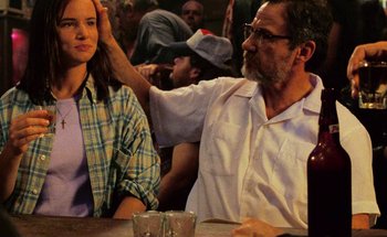 Movie still from “From Dusk Till Dawn” (1996), directed by Robert Rodriguez – An older man and a young woman sitting at a table; Close Up shot, Over the shoulder angle