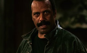 Movie still from “From Dusk Till Dawn” (1996), directed by Robert Rodriguez – A person with a mustache; Close Up shot, Low angle