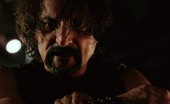 Movie still from “From Dusk Till Dawn” (1996), directed by Robert Rodriguez – A person with a beard; Close Up shot, Low angle