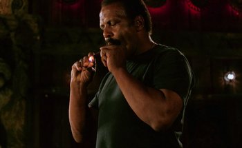 Movie still from “From Dusk Till Dawn” (1996), directed by Robert Rodriguez – A man brushing his teeth with an electric toothbrush; Close Up shot, Low angle