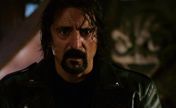 Movie still from “From Dusk Till Dawn” (1996), directed by Robert Rodriguez – A person wearing a leather jacket; Close Up shot, Low angle