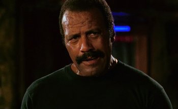 Movie still from “From Dusk Till Dawn” (1996), directed by Robert Rodriguez – A person with a mustache; Close Up shot, Low angle