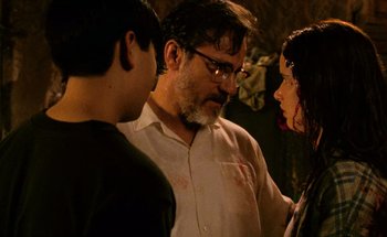 Movie still from “From Dusk Till Dawn” (1996), directed by Robert Rodriguez – A group of people standing next to each other in a room; Close Up shot, Over the shoulder angle