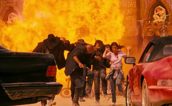 Movie still from “From Dusk Till Dawn” (1996), directed by Robert Rodriguez – A group of people running through a fire; Wide shot, Low angle