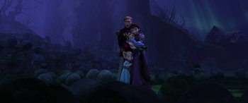 Movie still from “Frozen” (2013), directed by Jennifer Lee – A family of three is standing in the dark; Wide shot, Low angle