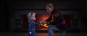 Movie still from “Frozen” (2013), directed by Jennifer Lee – A man and a little girl sitting in front of a fire place; Medium shot, Over the shoulder angle