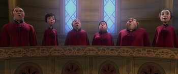 Movie still from “Frozen” (2013), directed by Jennifer Lee – A group of people standing next to each other in front of a window; Wide shot, Low angle