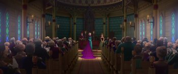 Movie still from “Frozen” (2013), directed by Jennifer Lee – An image of a woman in a purple dress in front of a group of people; Wide shot, Low angle