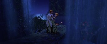 Movie still from “Frozen” (2013), directed by Jennifer Lee – A man and a woman standing next to each other on top of a hill; Wide shot, Low angle