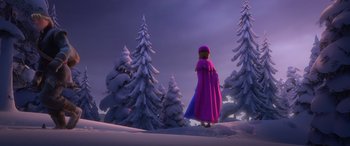 Movie still from “Frozen” (2013), directed by Jennifer Lee – A woman in a purple cape standing in the snow; Extreme Wide shot, Over the shoulder angle