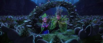 Movie still from “Frozen” (2013), directed by Jennifer Lee – A man and a woman dressed in costumes in a forest; Wide shot, Over the shoulder angle