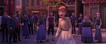 Movie still from “Frozen II” (2019), directed by Jennifer Lee – A group of people standing in the middle of a street; Wide shot, Over the shoulder angle