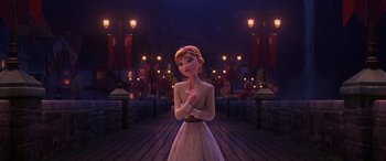 Movie still from “Frozen II” (2019), directed by Jennifer Lee – A woman standing in front of a street at night; Wide shot, Over the shoulder angle