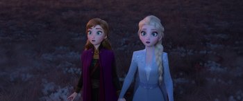Movie still from “Frozen II” (2019), directed by Jennifer Lee – A couple of women standing next to each other in a field; Medium shot, Over the shoulder angle