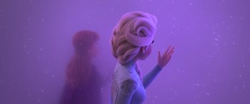 Movie still from “Frozen II” (2019), directed by Jennifer Lee – A woman standing next to another woman in front of a purple background; Medium shot, Over the shoulder angle
