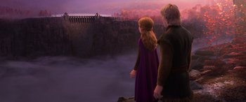 Movie still from “Frozen II” (2019), directed by Jennifer Lee – A couple of people standing next to each other near a body of water; Extreme Wide shot, High angle