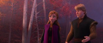 Movie still from “Frozen II” (2019), directed by Jennifer Lee – A woman in a purple coat standing in front of a forest; Medium shot, Over the shoulder angle