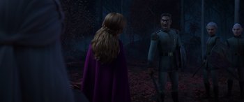 Movie still from “Frozen II” (2019), directed by Jennifer Lee – A woman in a purple dress and a man in a blue uniform; Medium shot, Over the shoulder angle